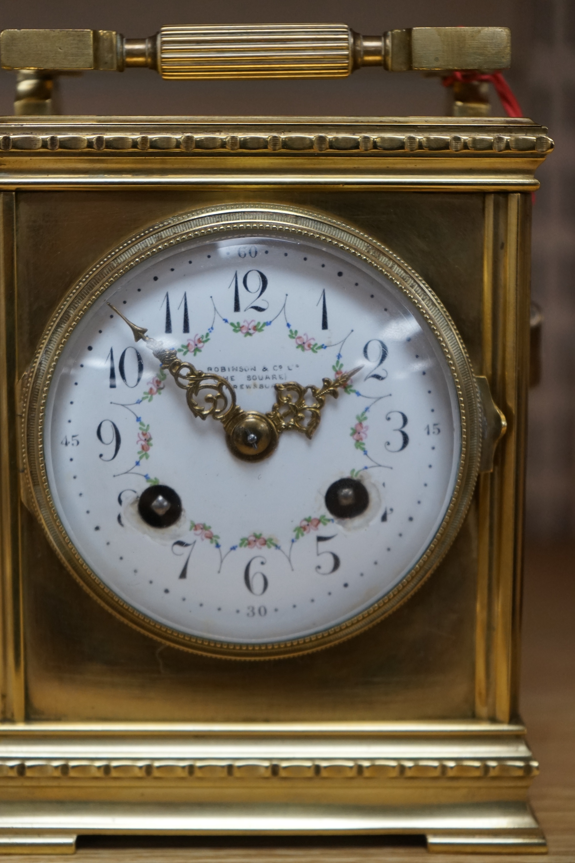 A late 19th century French brass large carriage clock with convex enamel dial, retailed by Robinson & Co. with key, 17cm. Condition - fair to good, not tested as working